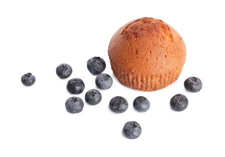 Delicious sweet muffin and blueberries isolated on whiteの写真素材