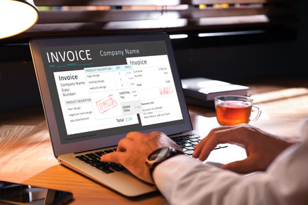 Man using laptop to pay bills at home, closeupの写真素材