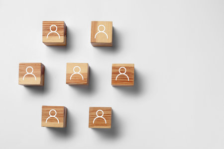 Human resource. Wooden cubes with human icons on light gray background, top viewの写真素材
