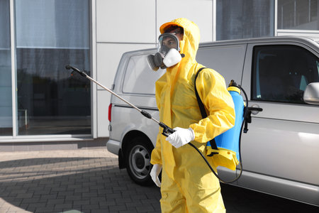 Pest control worker with spray tank outdoorsの写真素材