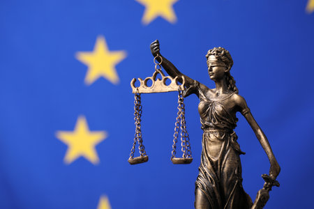 Figure of Lady Justice against European Union flag. Space for textの写真素材