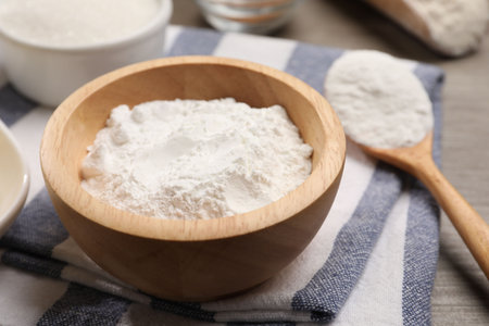 Baking powder in bowl on wooden table, closeupの写真素材
