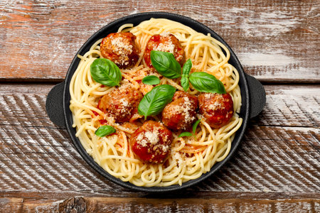Delicious pasta with meatballs on wooden table, top viewの写真素材