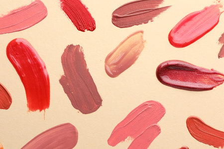Samples of different lip products on beige background, top viewの写真素材