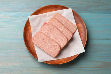 Pieces of meat on blue wooden table, top view