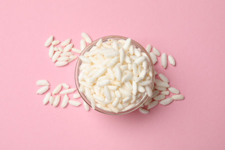 Puffed rice in bowl on light pink background, top viewの写真素材