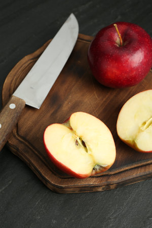 Fresh ripe red apples and knife on gray textured tableの写真素材