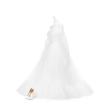 Mannequin with beautiful wedding dress and shoes isolated on whiteの写真素材