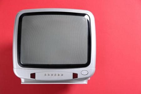 Retro TV set on red background, top viewの写真素材