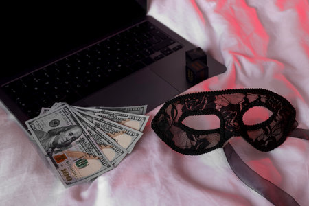 Laptop, dollar banknotes and mask on linesの写真素材