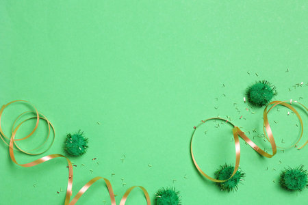 Festive composition with shiny confetti and party decor on green background, flat lay. Space for textの写真素材