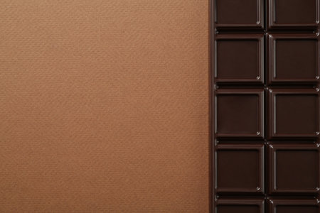 Tasty chocolate bar on brown background, top view. Space for textの写真素材