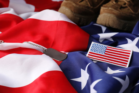 Veterans day. USA army patch, American flag and military shoes, closeupの写真素材