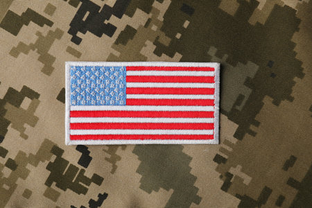 Veterans day. USA army patch on camouflage fabric, top viewの写真素材
