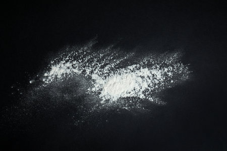 White snow falling down on black backgroundの写真素材