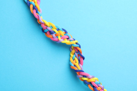 Braided colorful ropes on light blue background, top view. Unity conceptの写真素材