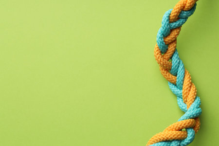 Colorful ropes tied together on light green background, top view and space for text. Unity conceptの写真素材