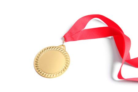 One golden medal with ribbon isolated on whiteの写真素材