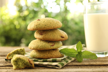 Delicious mint chocolate chip cookies and milk on wooden table, closeupの写真素材
