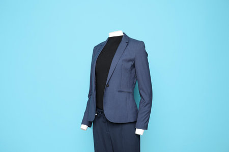 Female mannequin with stylish suit on light blue backgroundの写真素材