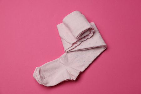 Beautiful child's tights on pink background, top viewの写真素材