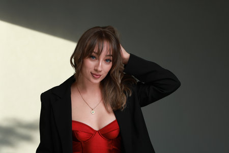 Attractive woman with stylish haircut against gray wallの写真素材