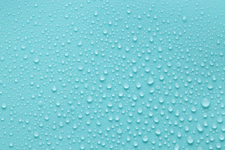 Water drops on turquoise background, above viewの写真素材