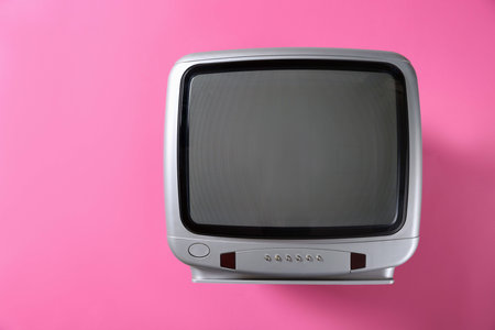 Retro TV set on pink background, top view. Space for textの写真素材