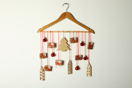 Handmade advent calendar with decor on hanger against white background. Christmas traditionの写真素材