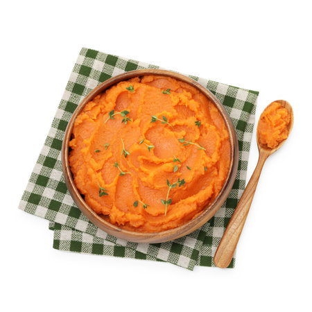 Tasty mashed sweet potato with thyme in bowl and spoon isolated on white, top viewの写真素材