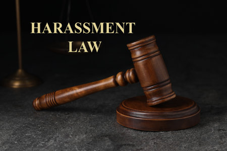 Harassment law. Judge's gavel on gray textured tableの写真素材