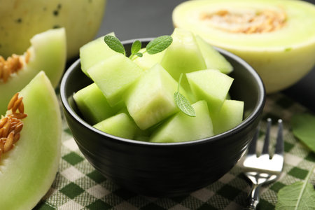 Slices of yummy melon on dark table, closeupの写真素材