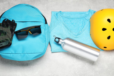 Bicycle accessories and bottle on gray textured background, flat layの写真素材