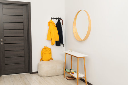 Mirror, rack with clothes and shoe storage bench in hallway. Interior designの写真素材