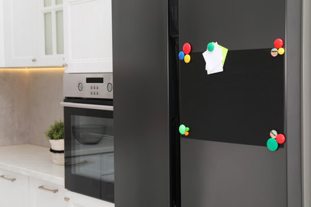 Blank magnetic board with notes on refrigerator in kitchenの写真素材