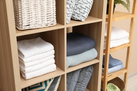Different home textile on shelving units indoors, closeupの写真素材