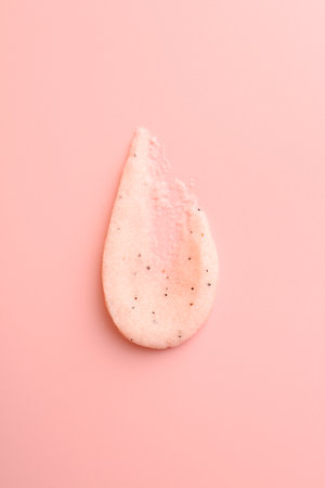 Smear of body scrub on light pink background, top viewの写真素材
