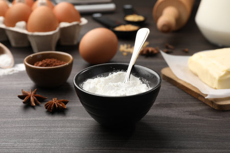 Baking powder and other products on gray wooden table, closeupの写真素材