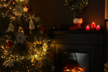 Fireplace with festive decor and Christmas tree indoorsの写真素材