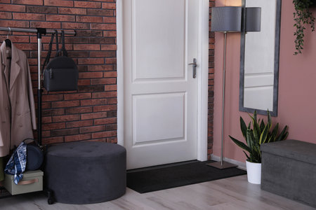 Stylish hallway interior with coat rack and mirrorの写真素材