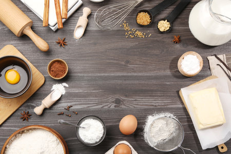 Frame of baking powder and other products on gray wooden table, flat lay. Space for textの写真素材