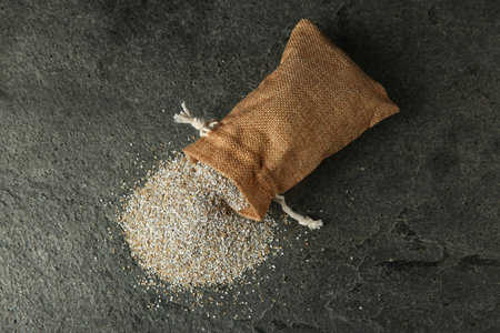 Sack with fresh rye bran on gray textured table, top viewの写真素材