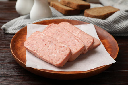 Canned meat and bread on wooden table, closeupの写真素材