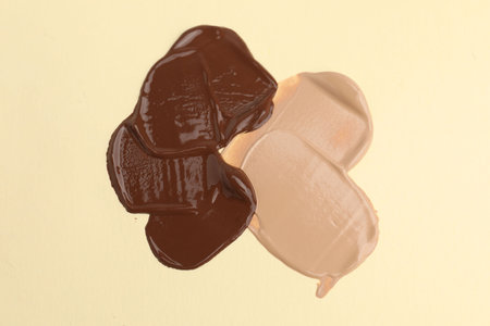 Samples of different foundations on beige background, above viewの写真素材