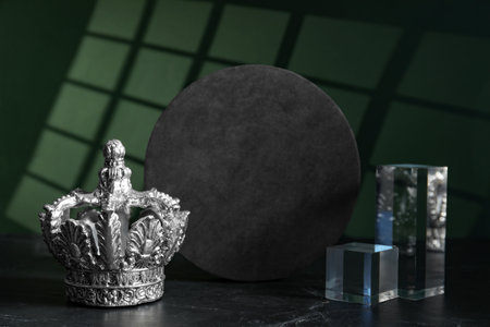 Stylish silver crown and geometric shapes on color background