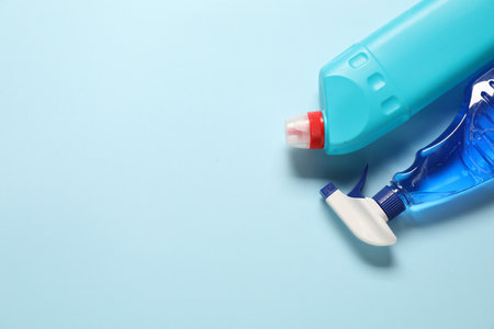 Cleaning products on light blue background, flat lay. Space for textの写真素材