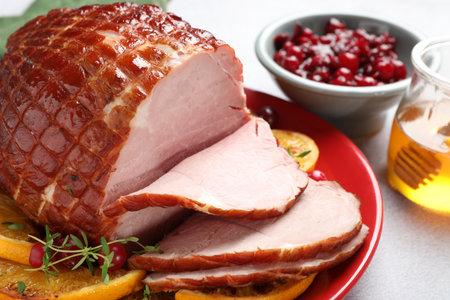 Tasty baked ham served on white table, closeupの写真素材
