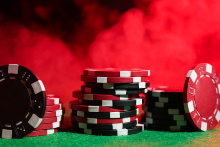 Poker game. Casino chips on green table in neon lights, closeupの写真素材
