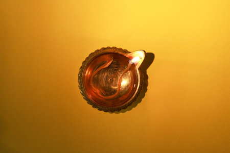 Diwali celebration. Diya lamp on orange background, top viewの写真素材