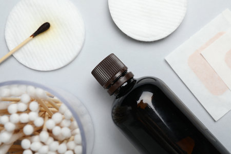 Topical iodine and other first aid kit components on light gray background, flat layの写真素材